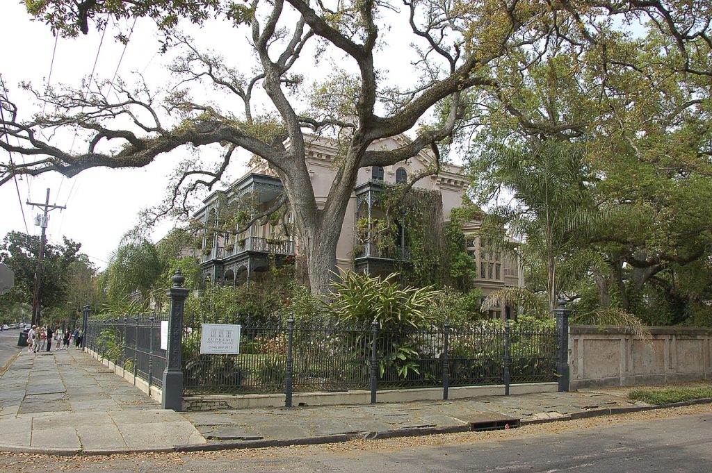 Historic Garden District mansion framed by live oak trees